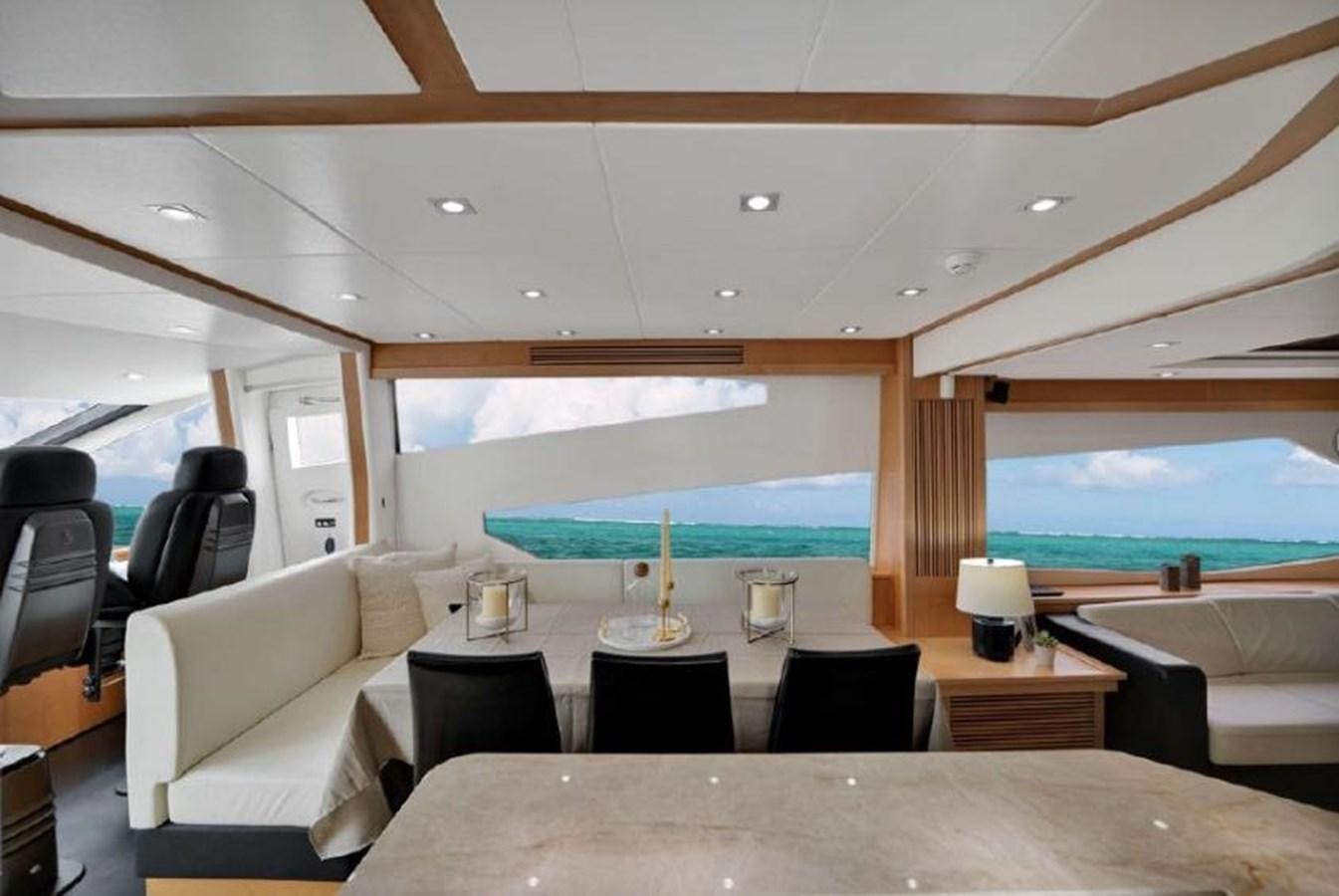 a room with a table chairs and a large swimming pool aboard SUNSEEKER 88  Yacht for Sale
