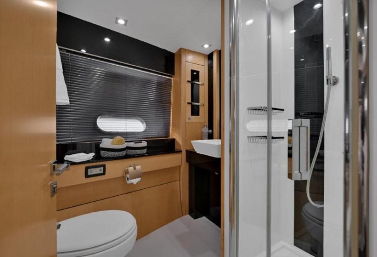 a bathroom with a shower unit and a toilet aboard SUNSEEKER 88  Yacht for Sale