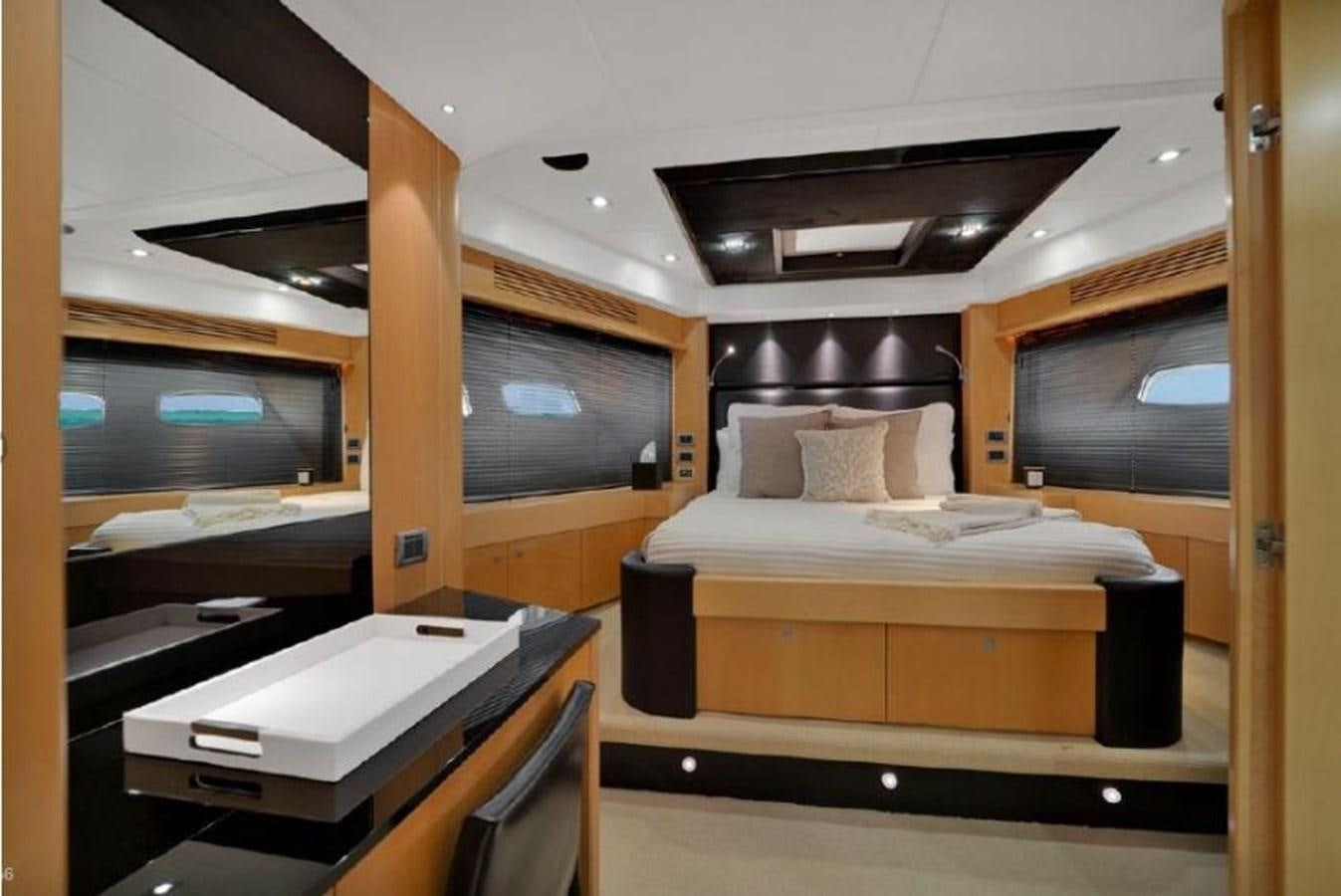 a room with a bed and a desk aboard SUNSEEKER 88  Yacht for Sale