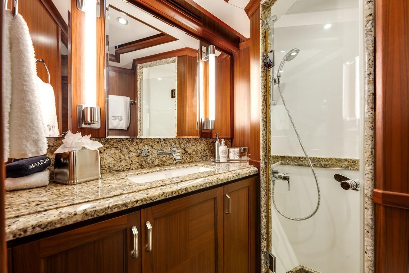 a bathroom with a countertop sink and a mirror aboard UNCORKED Yacht for Sale