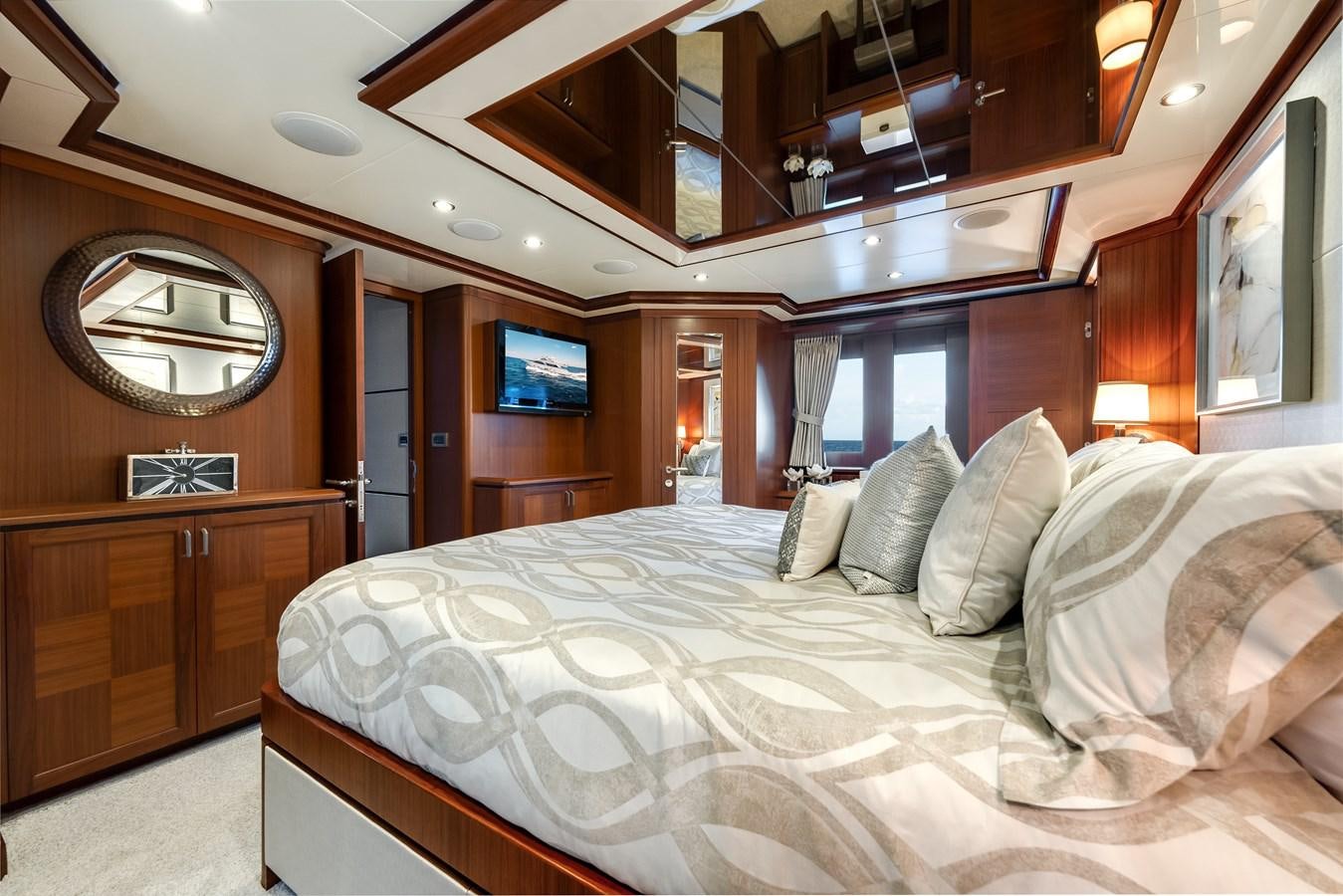 a bed with pillows and a mirror aboard UNCORKED Yacht for Sale