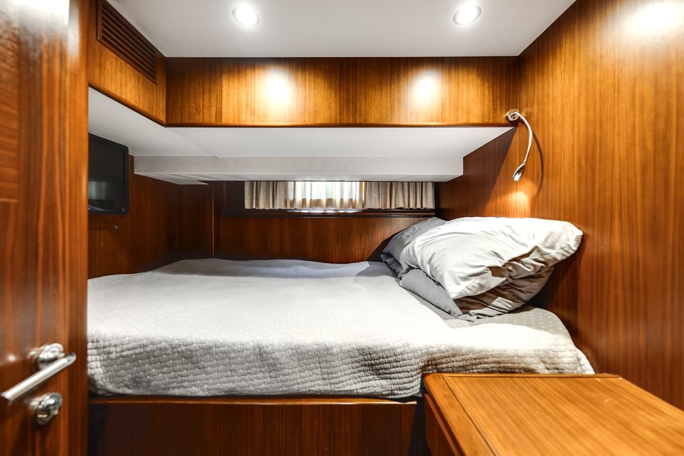 a bed with white sheets aboard UNCORKED Yacht for Sale