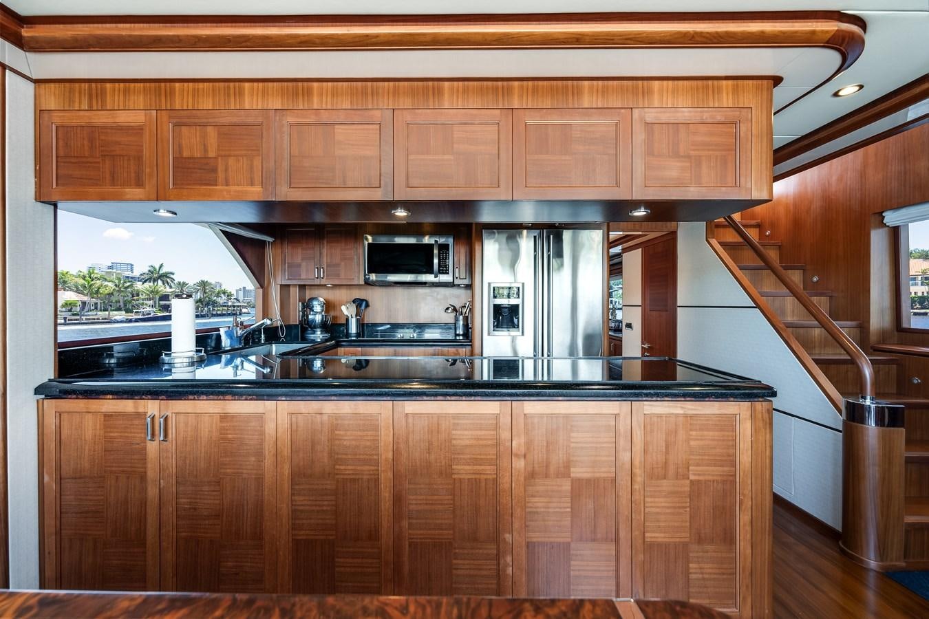 a kitchen with wooden cabinets aboard UNCORKED Yacht for Sale
