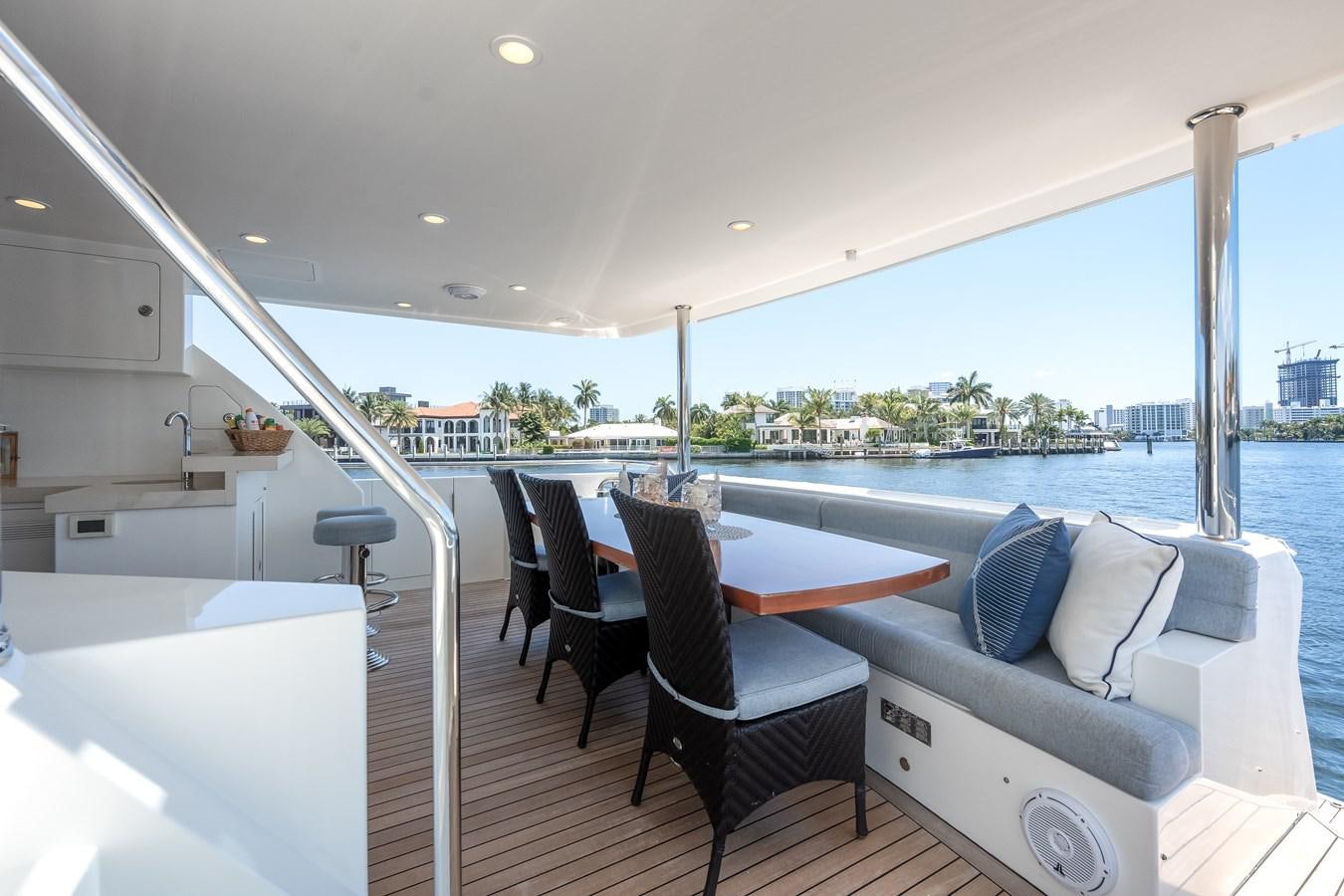 a room with a table chairs and a view of the water aboard UNCORKED Yacht for Sale