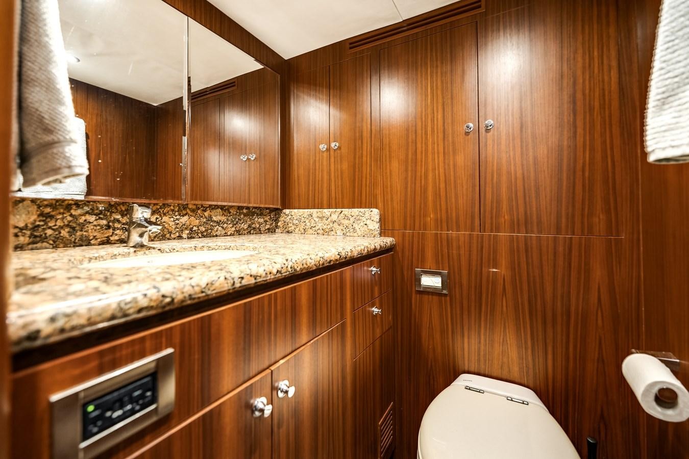 a bathroom with a countertop sink and wooden cabinets aboard UNCORKED Yacht for Sale