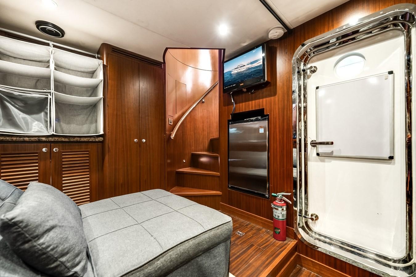 a room with a bed and a tv aboard UNCORKED Yacht for Sale