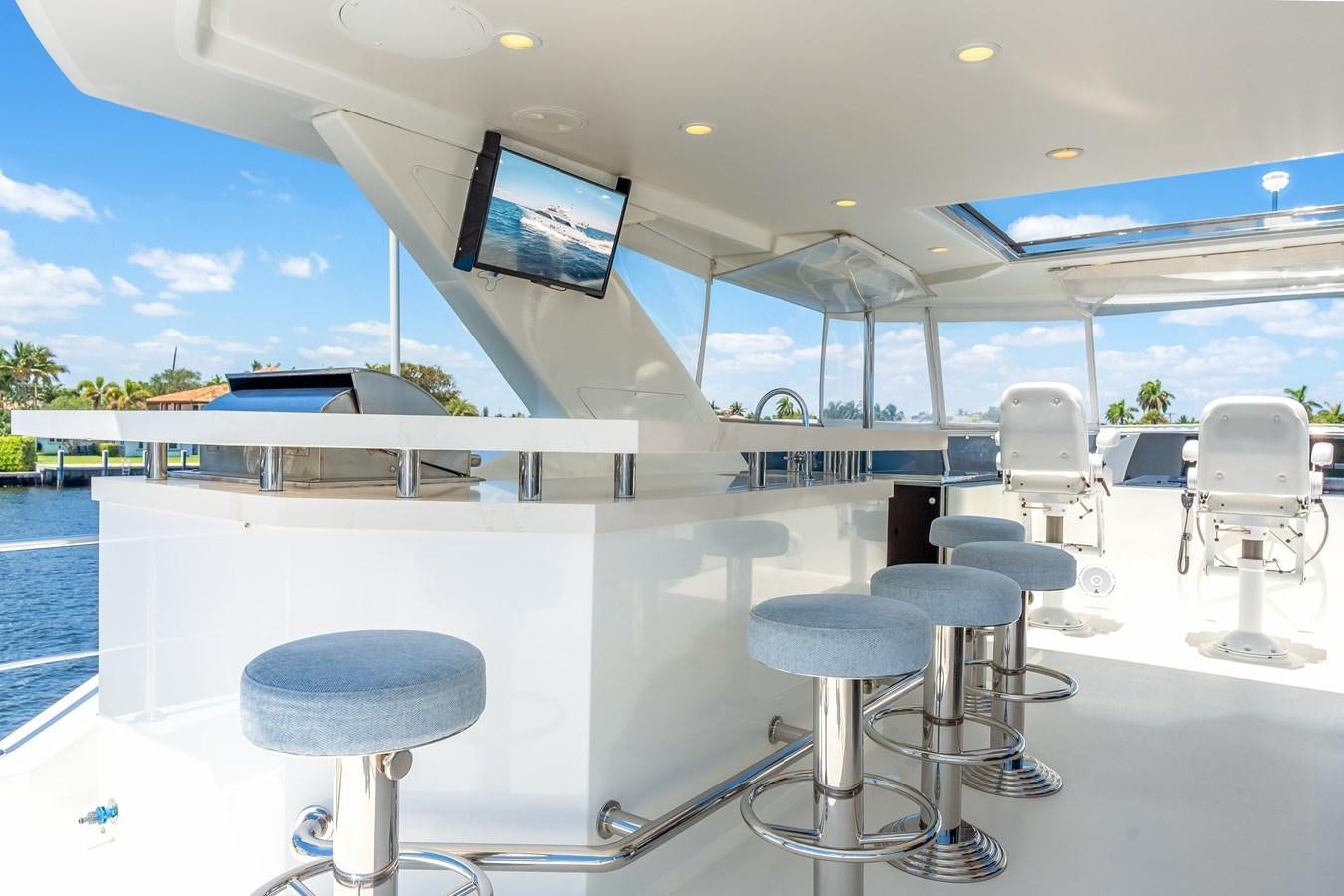 a room with stools and tables aboard UNCORKED Yacht for Sale