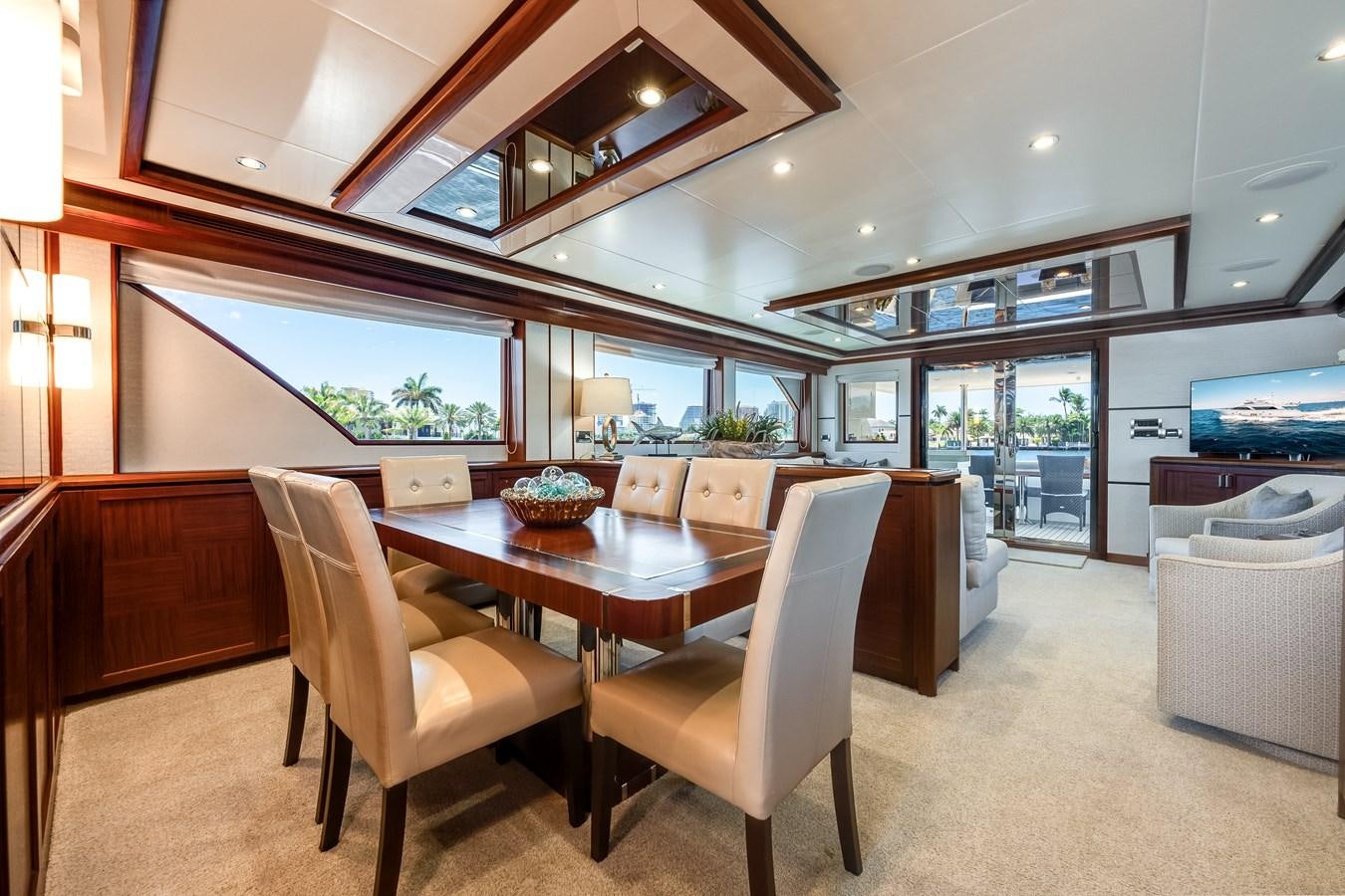 a room with a table chairs and a fireplace aboard UNCORKED Yacht for Sale