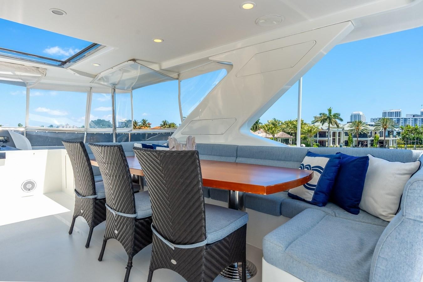 a large open area with a table and chairs and a large window aboard UNCORKED Yacht for Sale