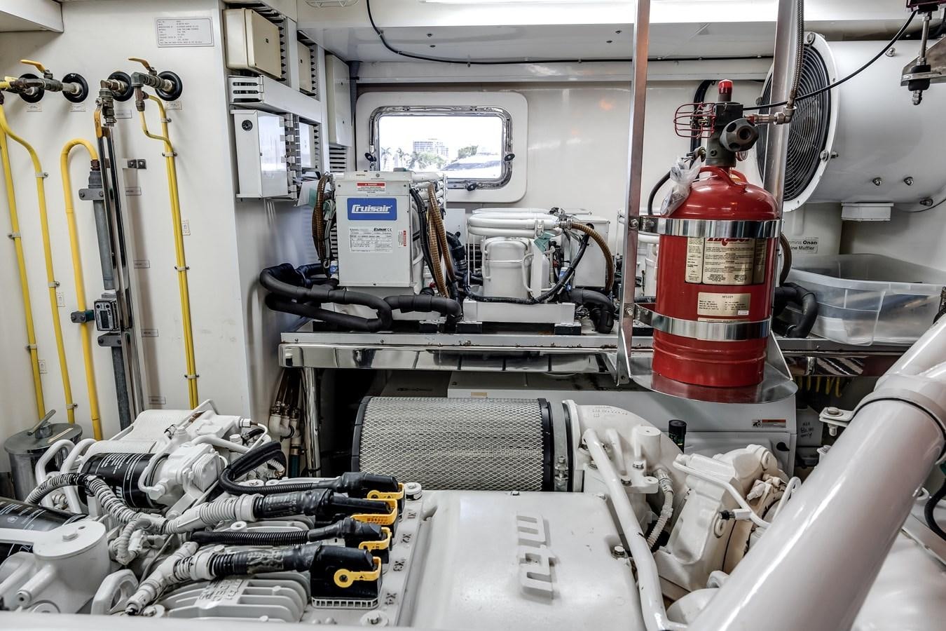 a red and yellow fire extinguisher in a room aboard UNCORKED Yacht for Sale
