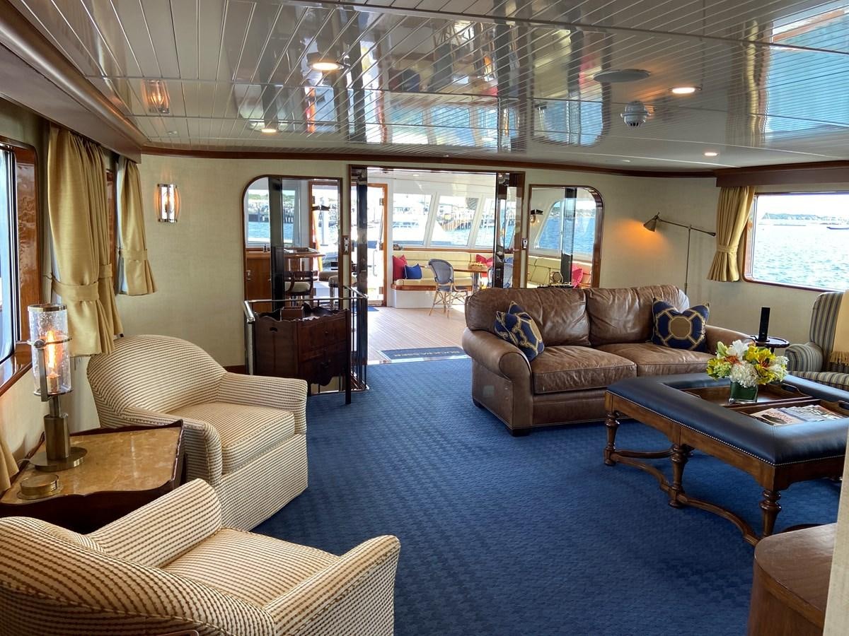 a living room with a blue carpet aboard BUCKPASSER Yacht for Sale