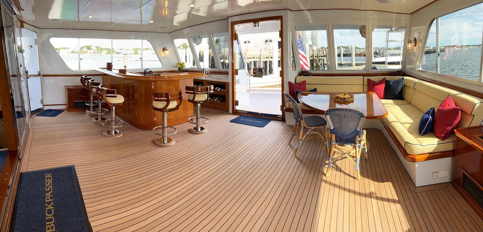 a room with tables chairs and a couch aboard BUCKPASSER Yacht for Sale