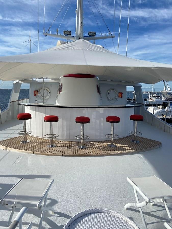 a white yacht with red stools aboard BUCKPASSER Yacht for Sale