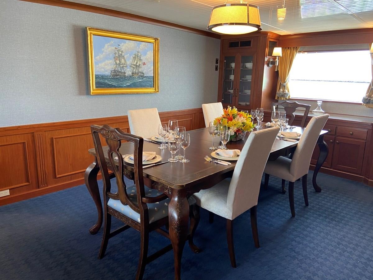 a dining table with chairs aboard BUCKPASSER Yacht for Sale