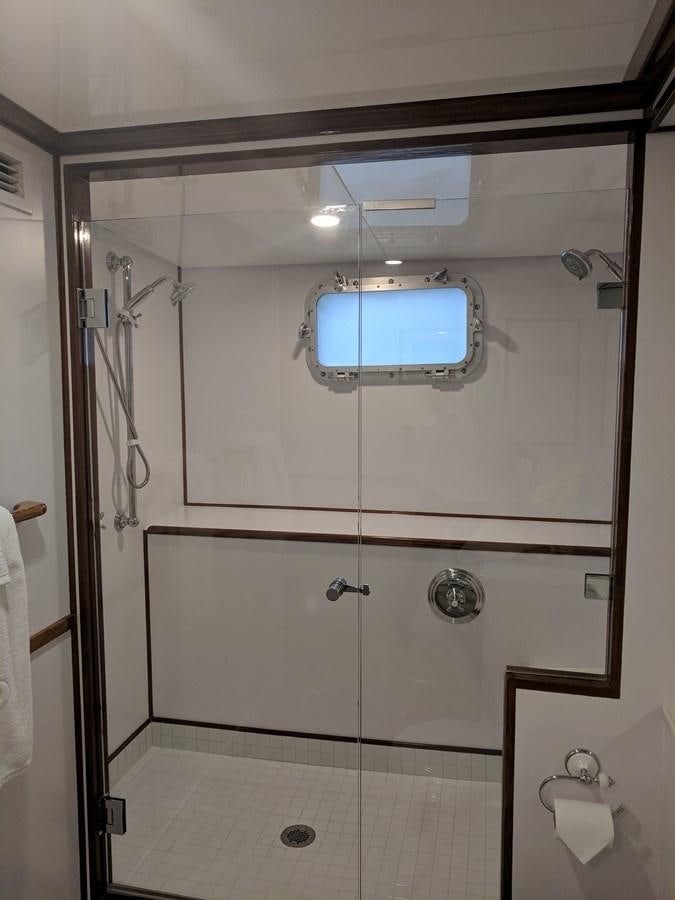 a bathroom with a shower unit aboard BUCKPASSER Yacht for Sale