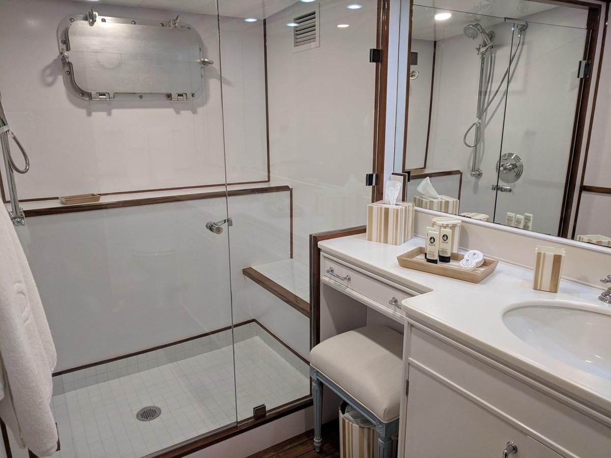 a bathroom with a shower and sink aboard BUCKPASSER Yacht for Sale