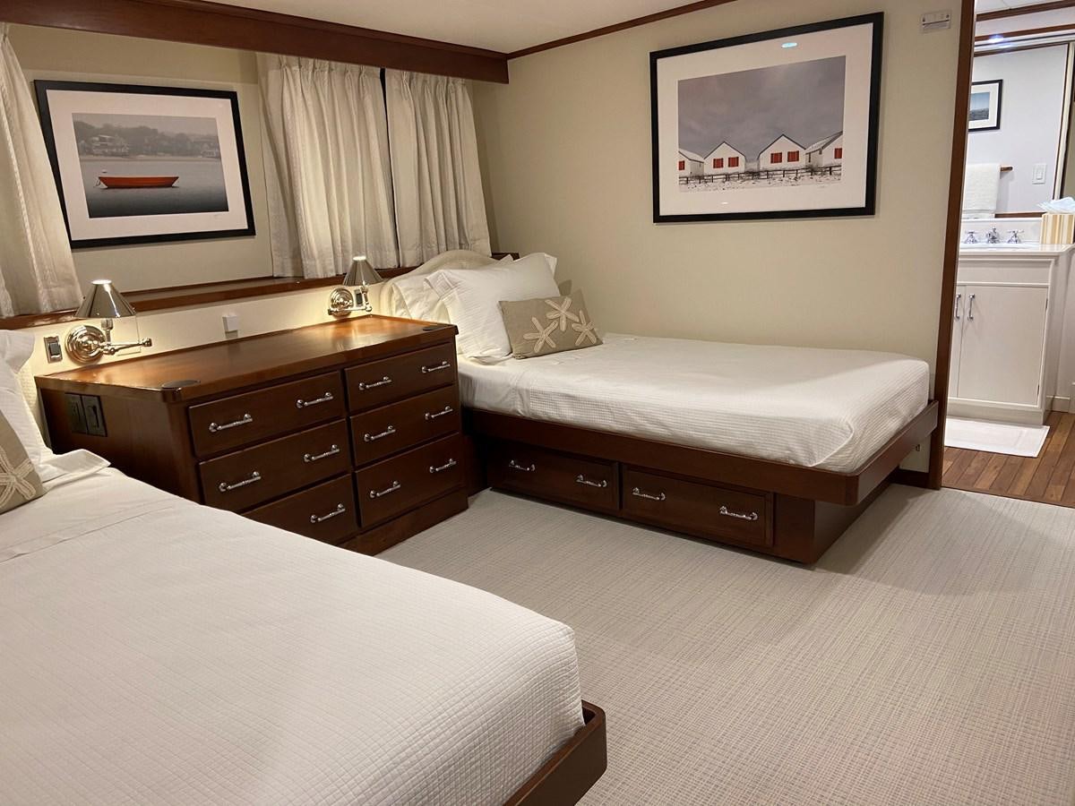 a hotel room with a bed and a dresser aboard BUCKPASSER Yacht for Sale