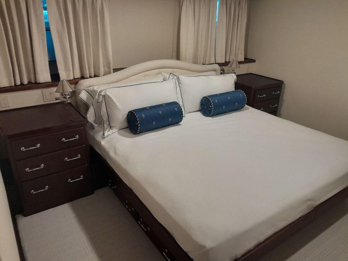 a bed with a blue pillow aboard BUCKPASSER Yacht for Sale