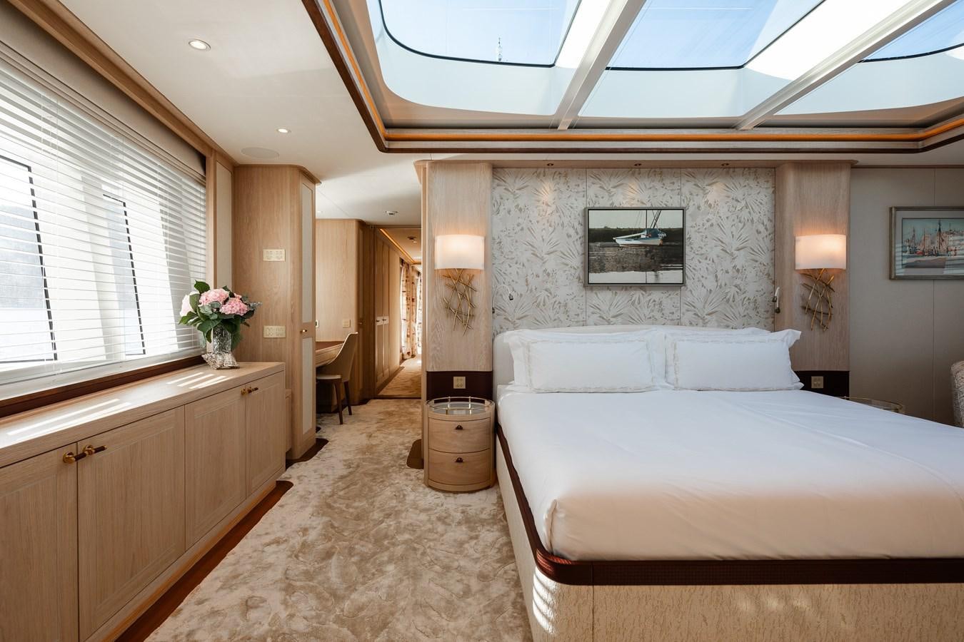 a bedroom with a bed and a desk aboard SEAFLOWER Yacht for Sale