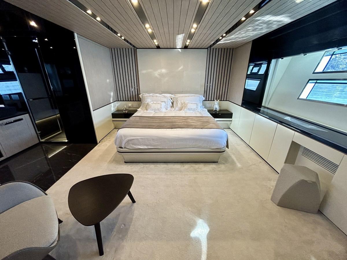 a room with a bed and chairs aboard SHERPA 80 Yacht for Sale
