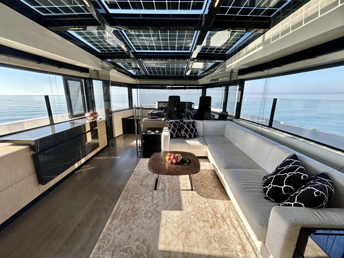 a large room with a couch and a coffee table aboard SHERPA 80 Yacht for Sale