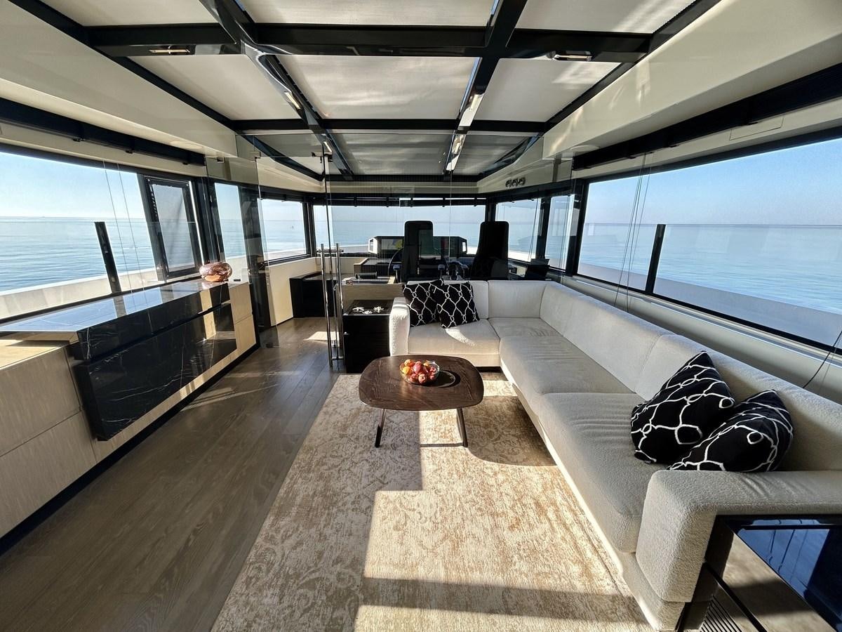 inside of a room with a couch and a table aboard SHERPA 80 Yacht for Sale