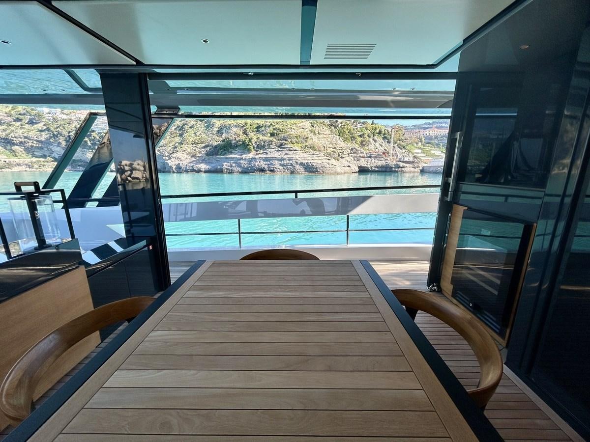 a deck with a view of a lake and trees aboard SHERPA 80 Yacht for Sale
