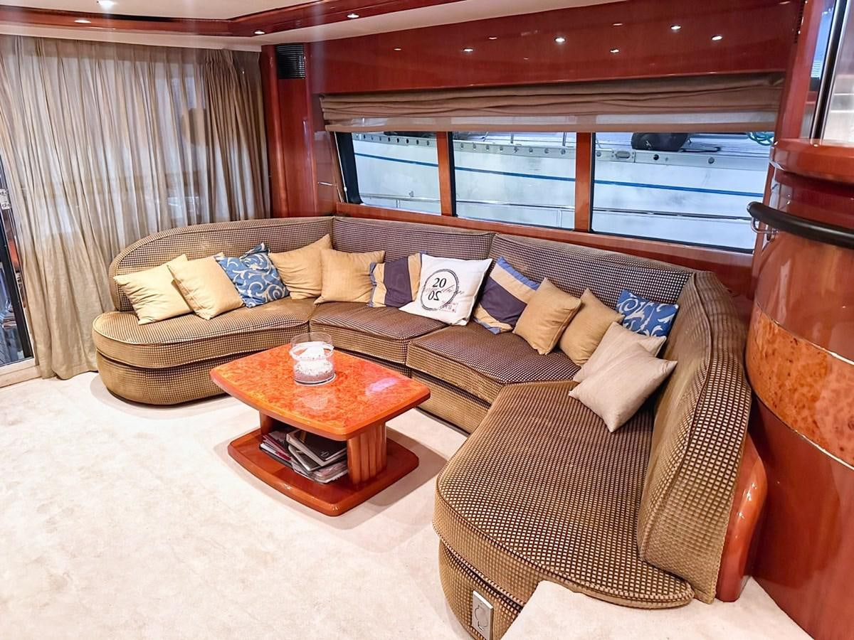 a living room with a couch and a coffee table aboard WET ASSET Yacht for Sale