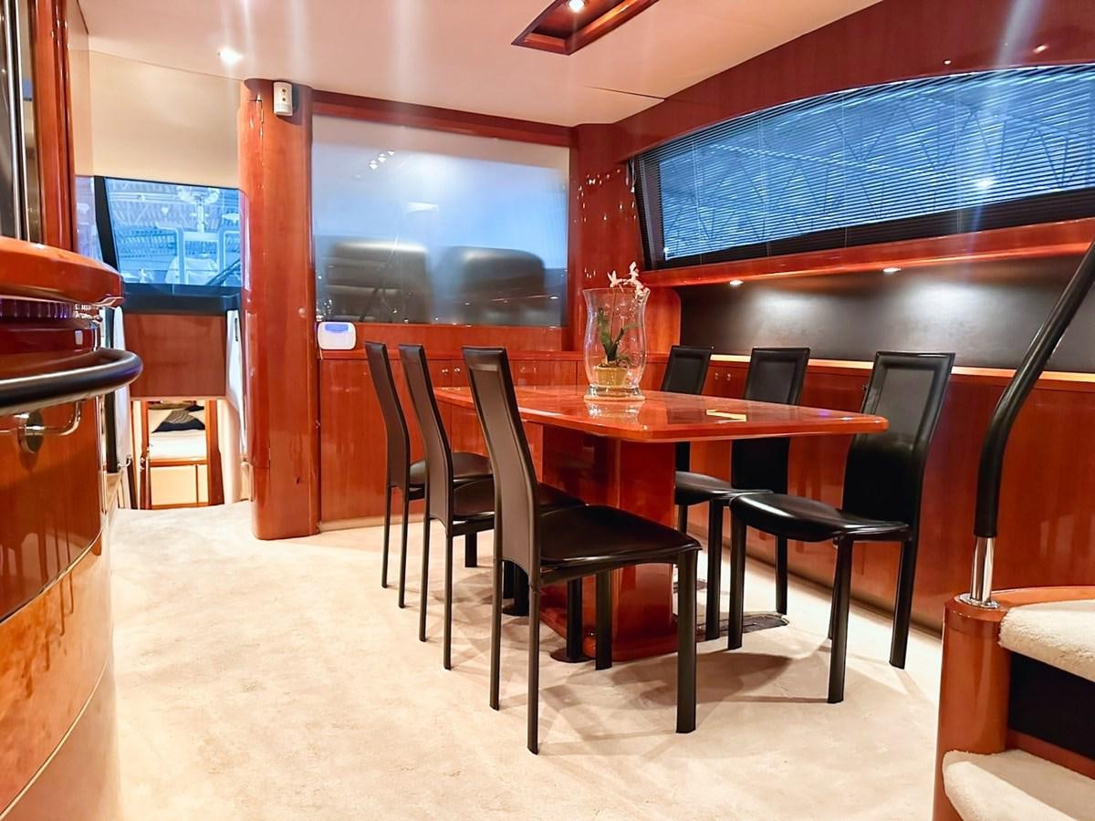 a restaurant with a table and chairs aboard WET ASSET Yacht for Sale