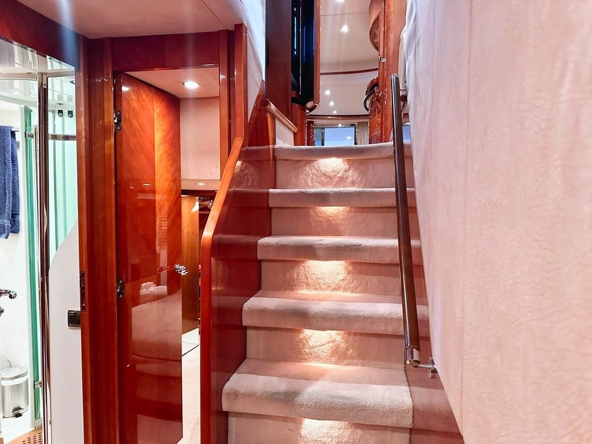 a wooden staircase in a building aboard WET ASSET Yacht for Sale