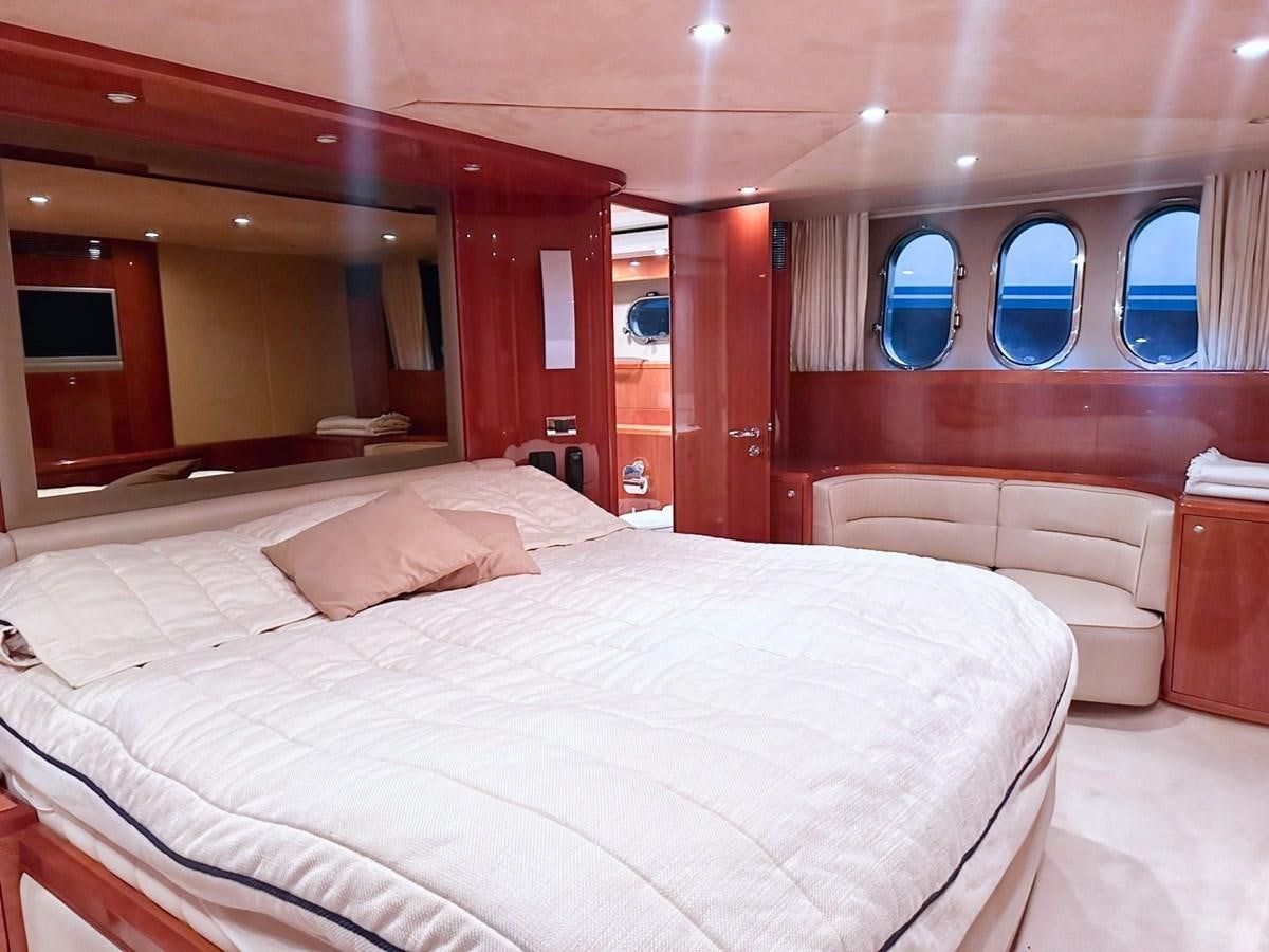 a room with a bed and a mirror aboard WET ASSET Yacht for Sale