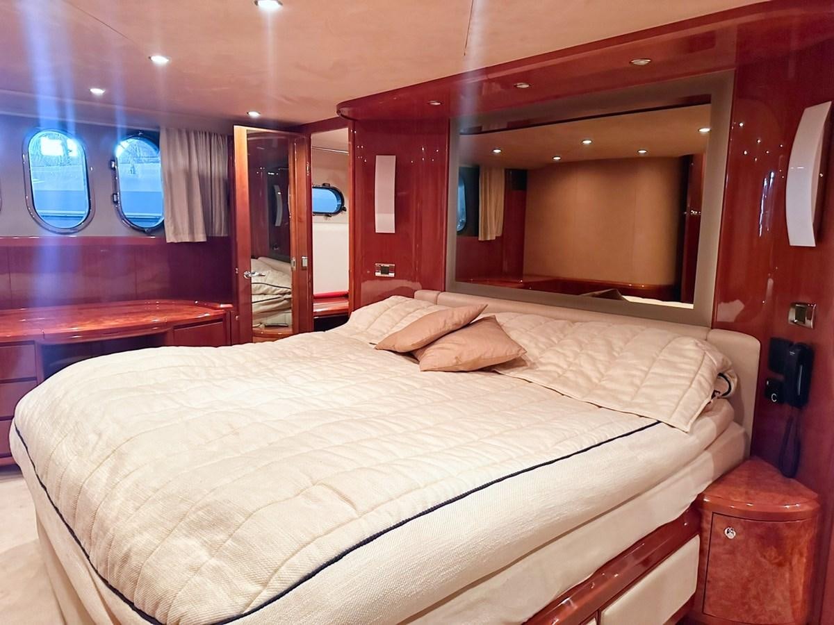 a bed with a white sheet aboard WET ASSET Yacht for Sale