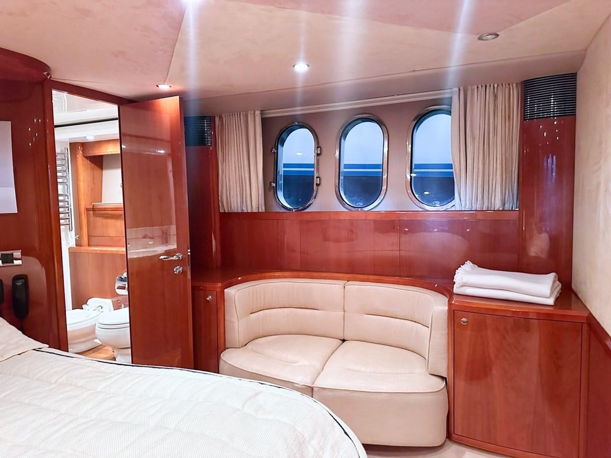 a room with a bed and a mirror aboard WET ASSET Yacht for Sale