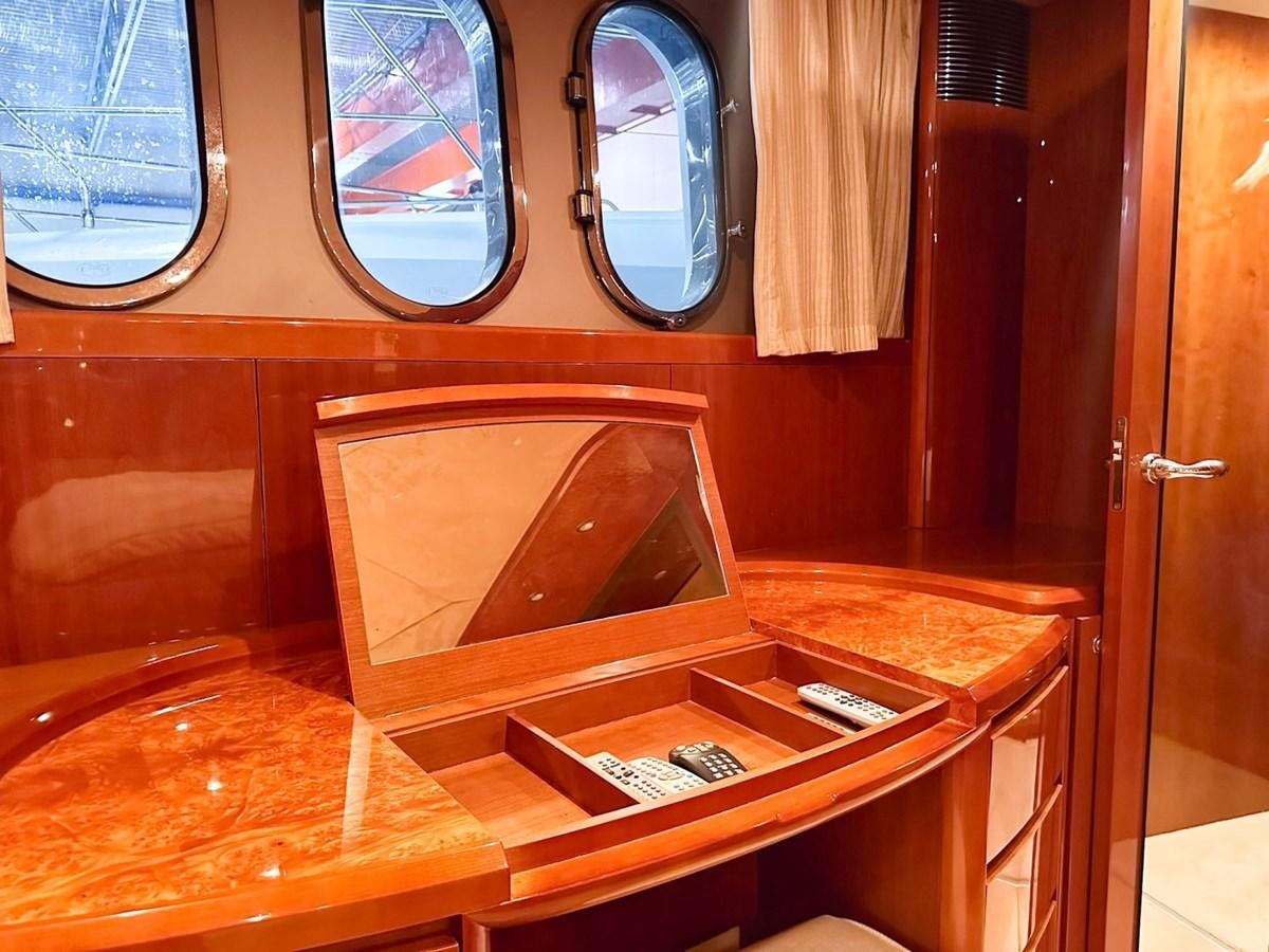 a wooden desk with a book on it aboard WET ASSET Yacht for Sale