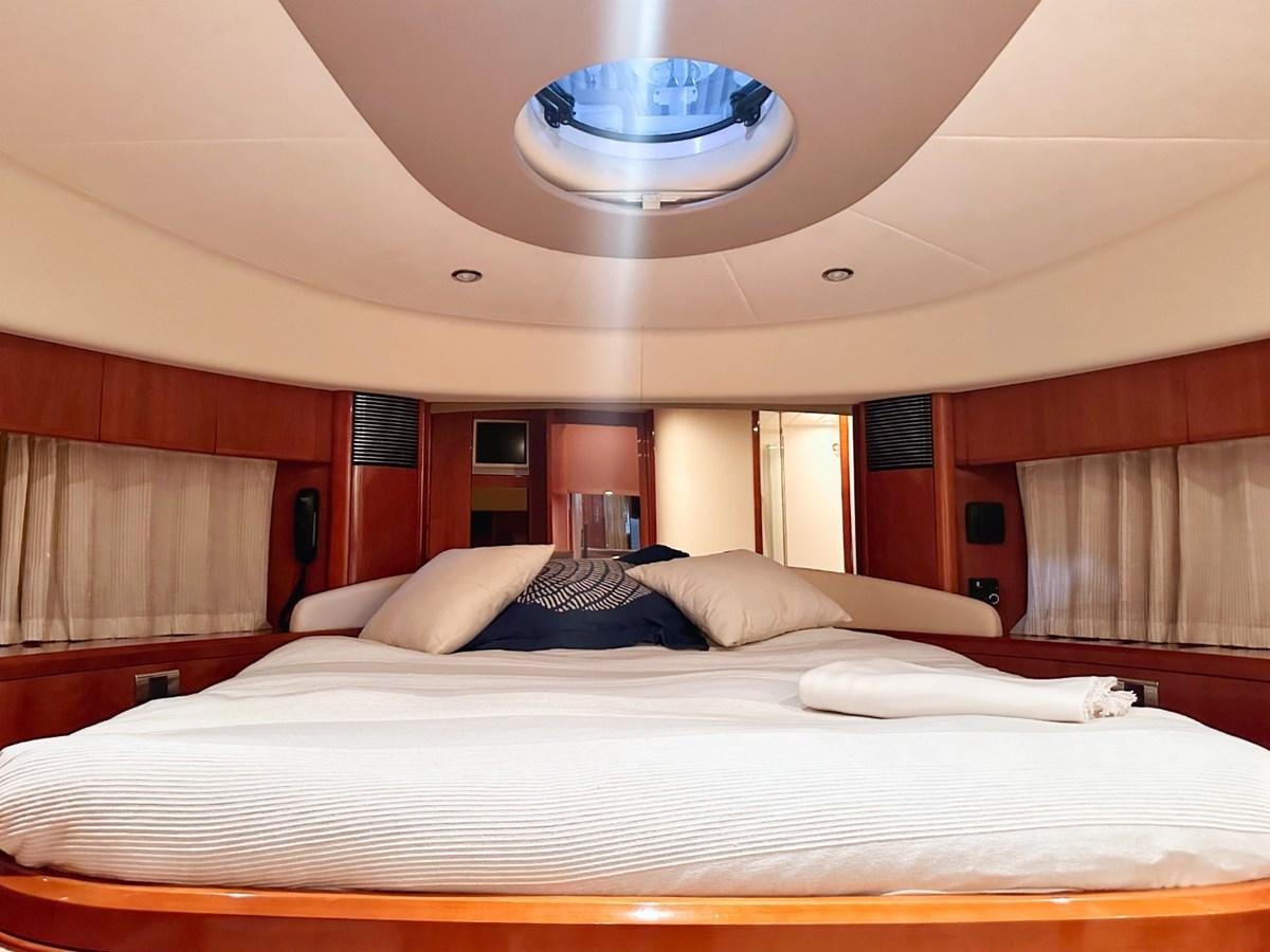 a bed with white sheets aboard WET ASSET Yacht for Sale