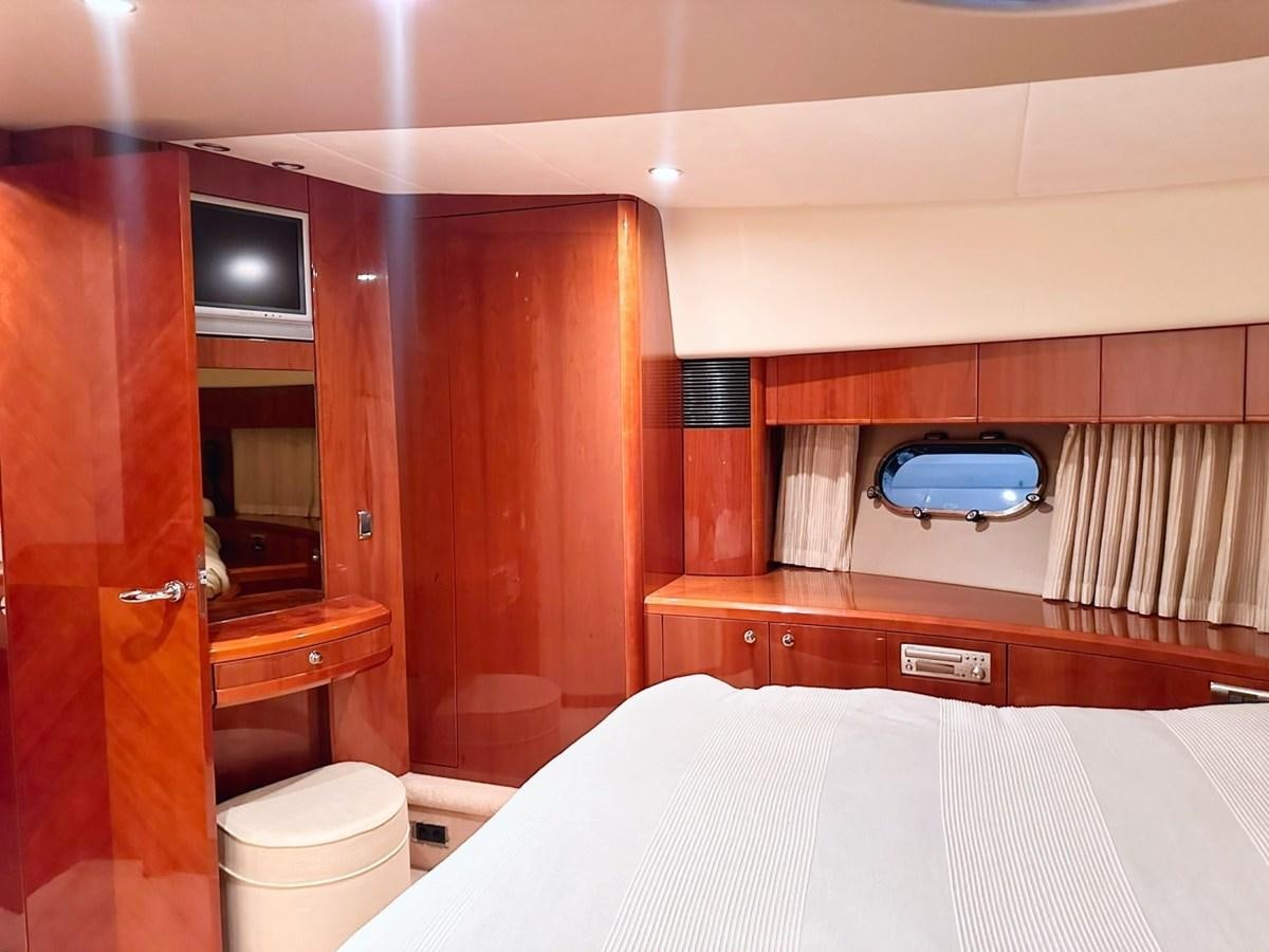 a room with a bed and a television aboard WET ASSET Yacht for Sale