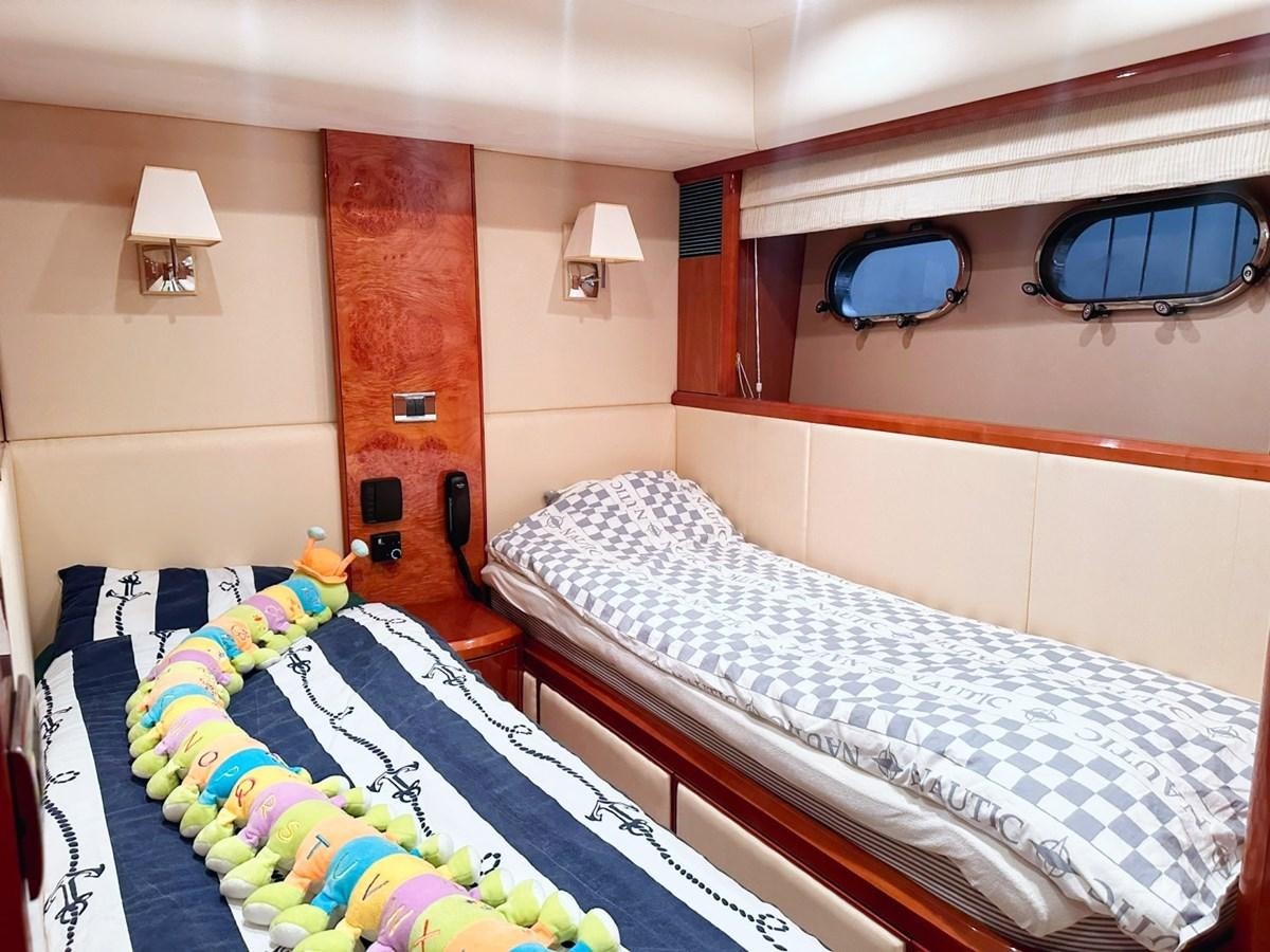 a room with two beds aboard WET ASSET Yacht for Sale