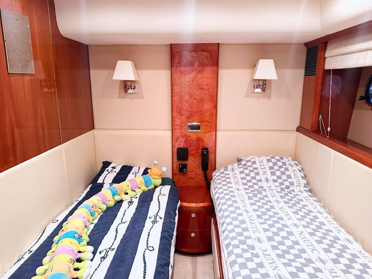 a room with a bed and a lamp aboard WET ASSET Yacht for Sale