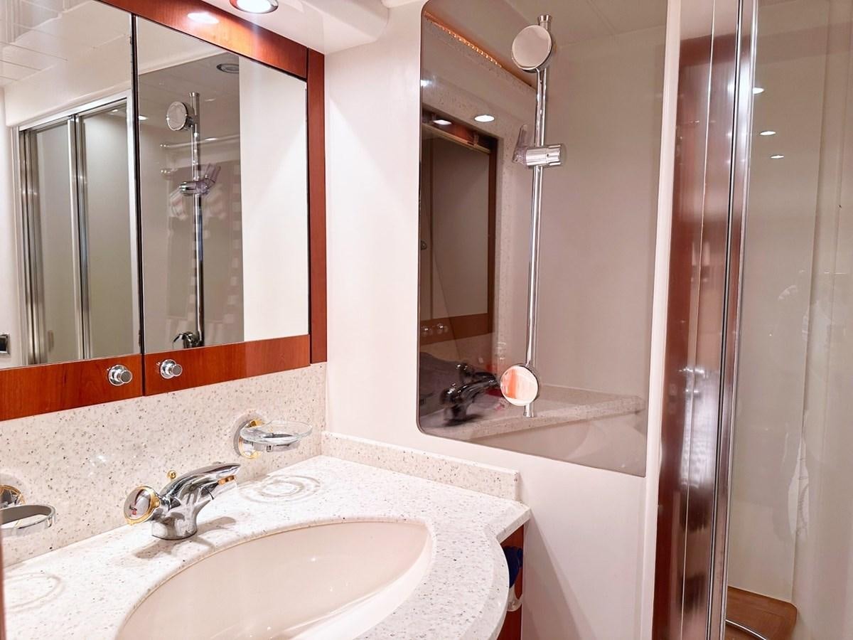 a bathroom with a sink and a mirror aboard WET ASSET Yacht for Sale