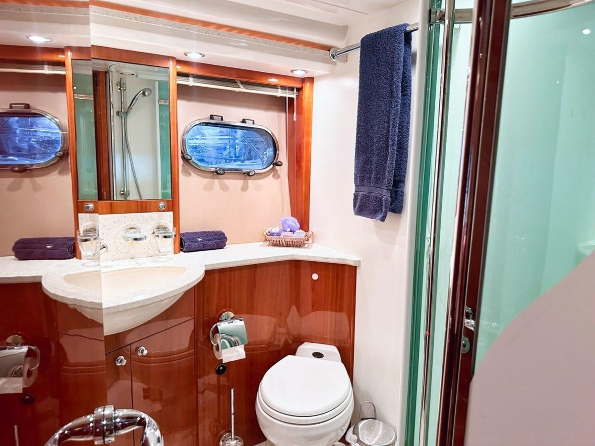 a bathroom with a toilet and sink aboard WET ASSET Yacht for Sale
