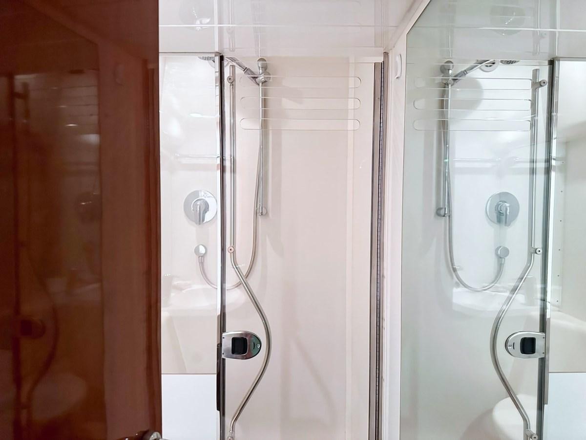 a bathroom with a shower and tub aboard WET ASSET Yacht for Sale