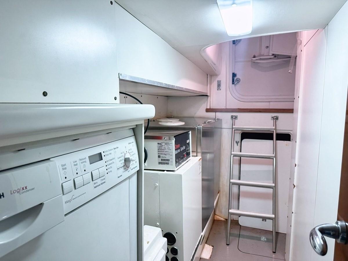 a white kitchen with white cabinets aboard WET ASSET Yacht for Sale