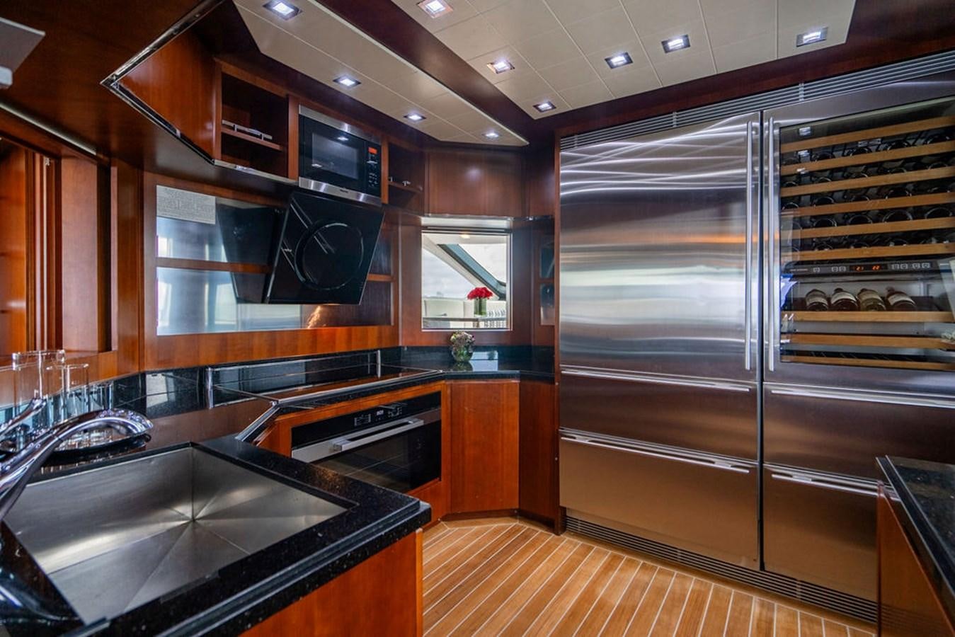 a kitchen with a large stainless steel refrigerator aboard MY GIRL Yacht for Sale