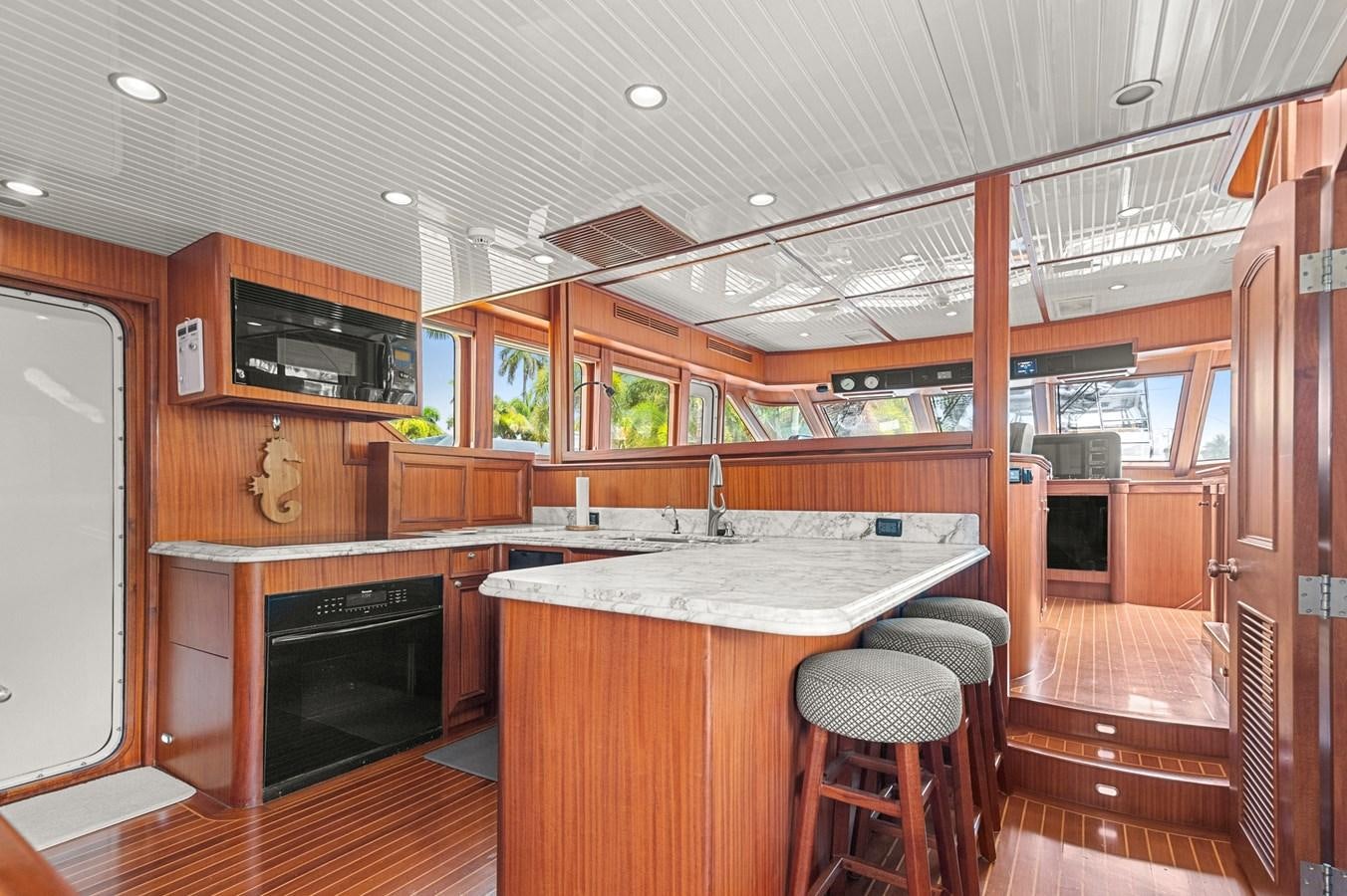 a kitchen with a bar and a fireplace aboard SEAS TO SEE Yacht for Sale