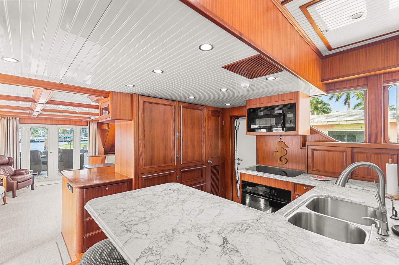 a kitchen with wooden cabinets aboard SEAS TO SEE Yacht for Sale