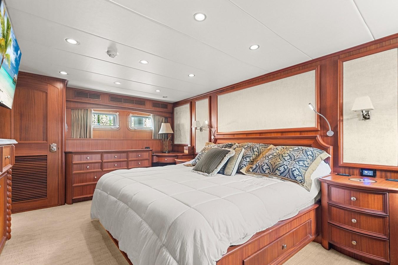 a bedroom with a bed and a desk aboard SEAS TO SEE Yacht for Sale