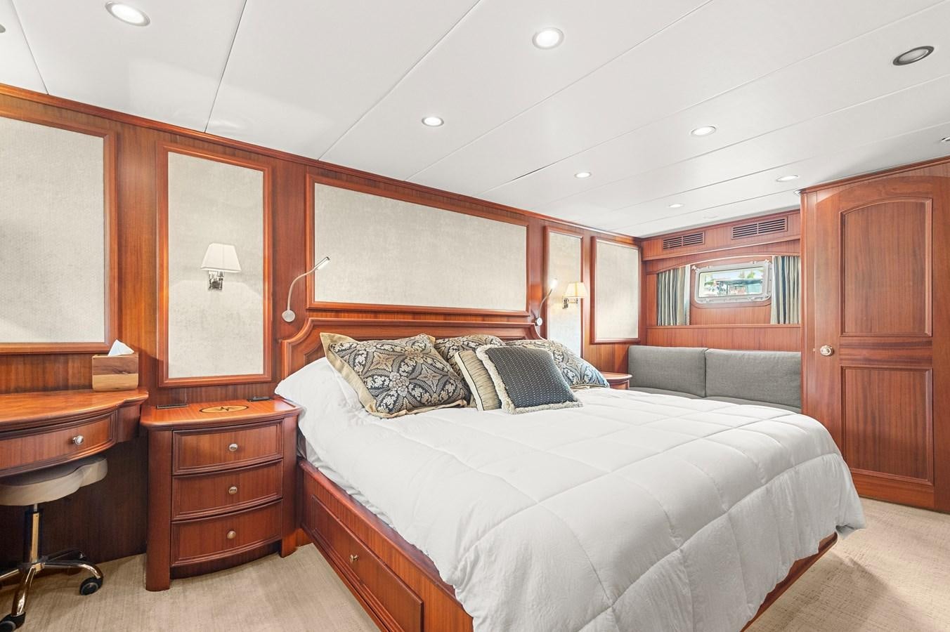 a bedroom with a bed and a desk aboard SEAS TO SEE Yacht for Sale