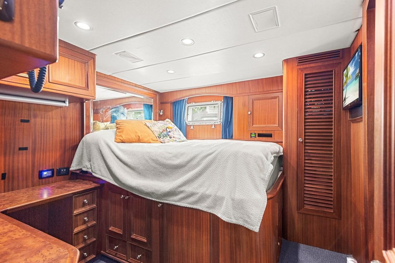a bedroom with a bed and cabinets aboard SEAS TO SEE Yacht for Sale