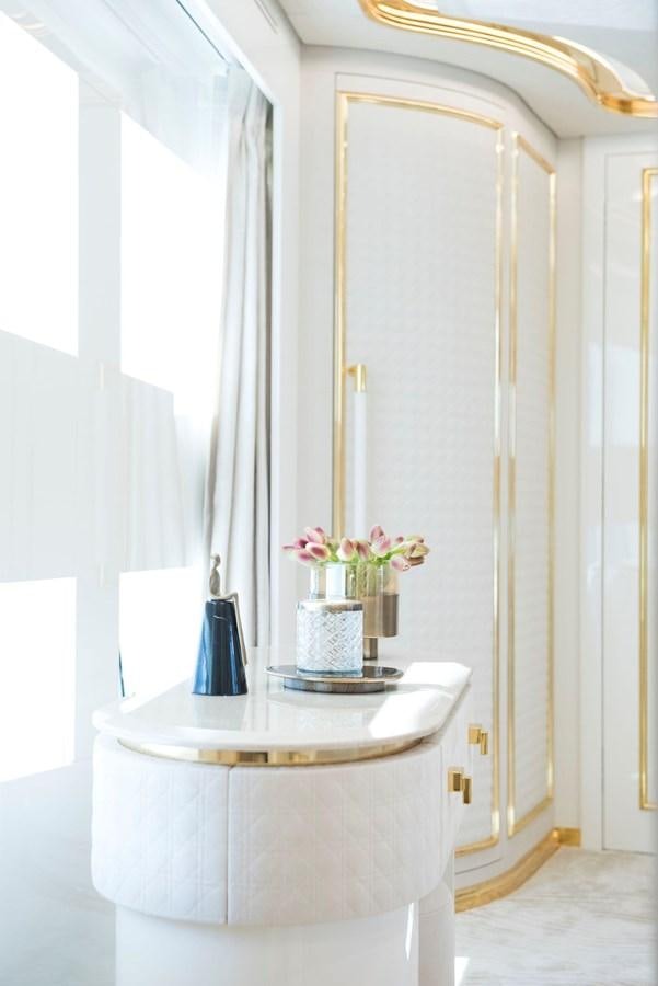 a white pedestal with a vase of flowers on it aboard SANDRO Yacht for Sale