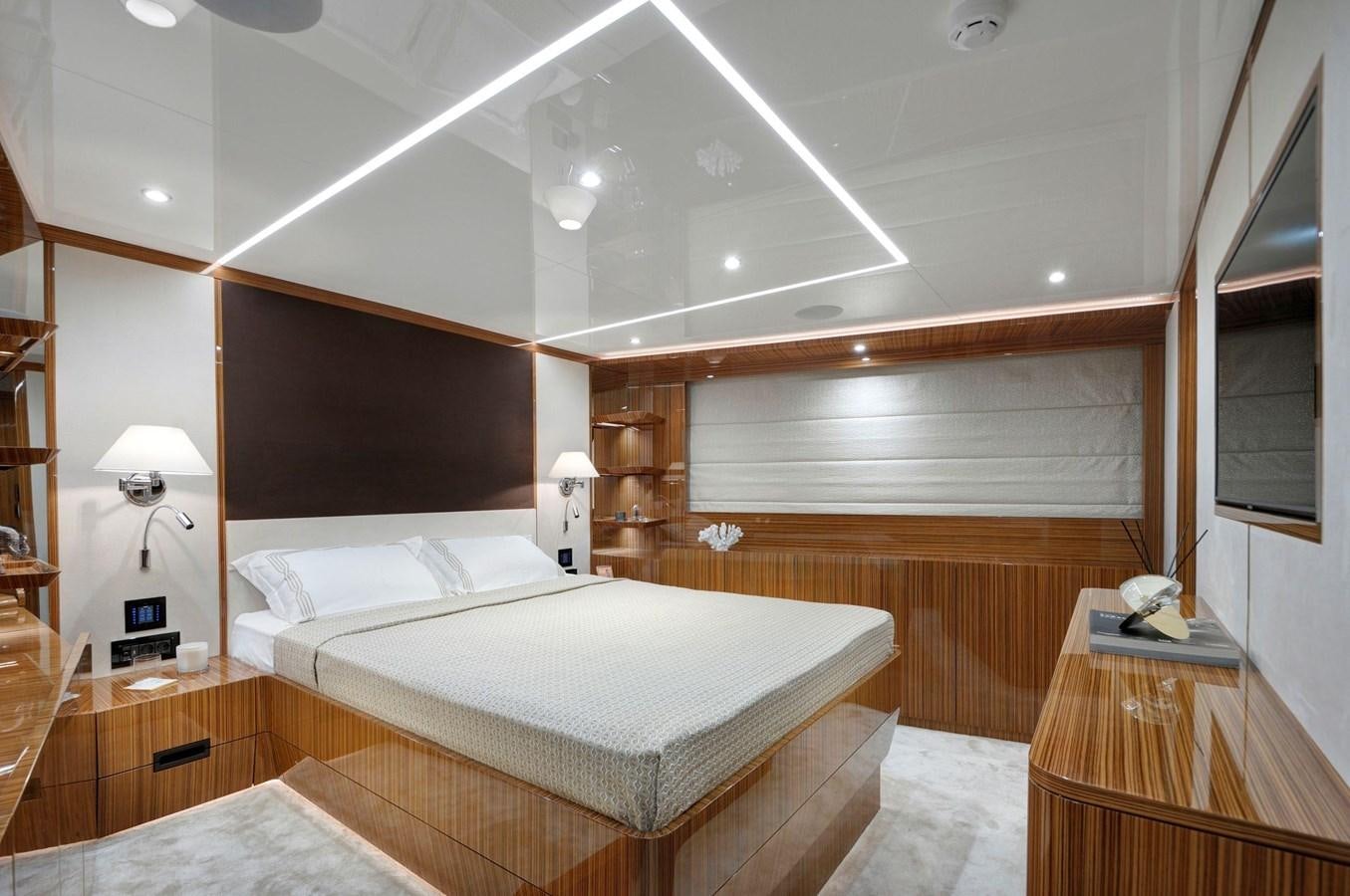 a room with a bed and a table aboard SANDRO Yacht for Sale
